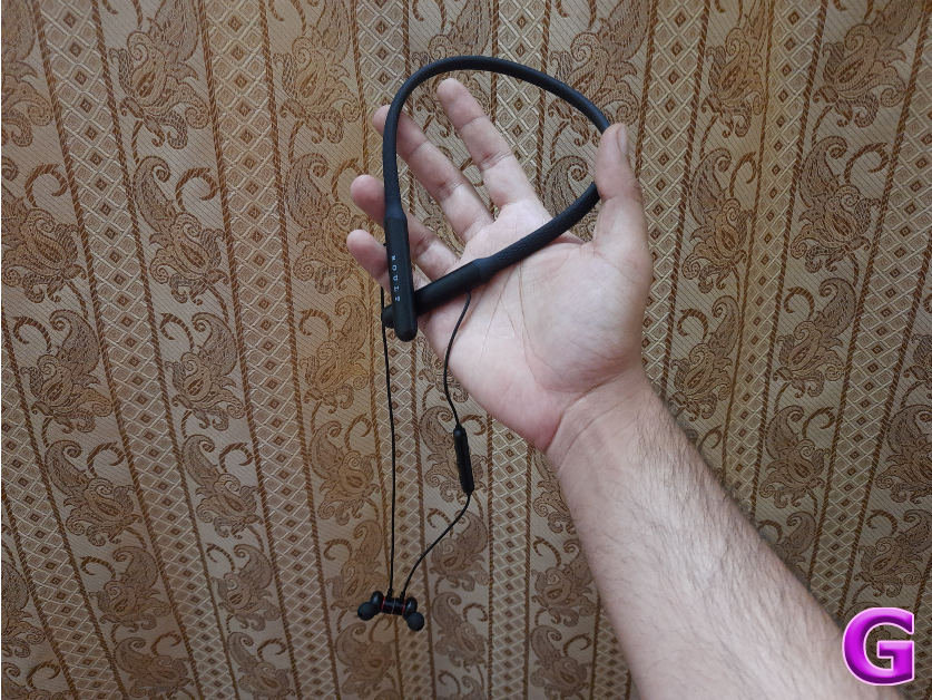 neckband hanging from a hand