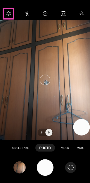 Step 1: Launch the Camera app on your phone and hit the gear icon at the top left corner of the screen.